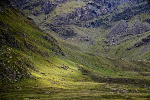 evening landscape mountains light green grass photo