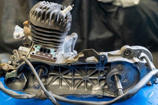 Disassembled motorcycle engine undergoing repair in workshop photo