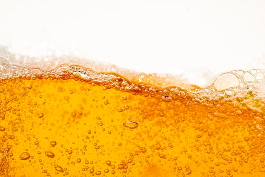 Close up bright orange Oil or beer splash texture and nature waves, Beautiful waves curve and little bubbles smooth for graphic design and background Oil Bubbles photo