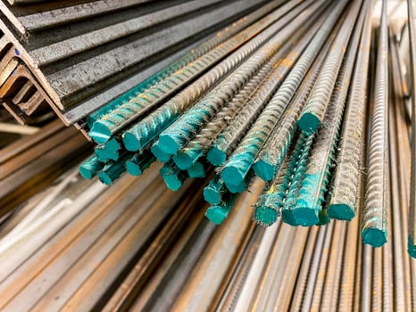 A considerable number of steel bars are meticulously stacked on top of one another, creating a structured arrangement that is often used in construction and engineering projects photo