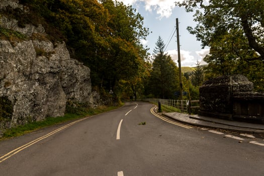 Winding road leading through llyn vyrnwy dam in wales photo