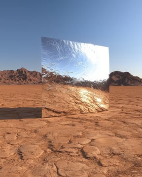 Reflective metallic structure in a desert landscape photo