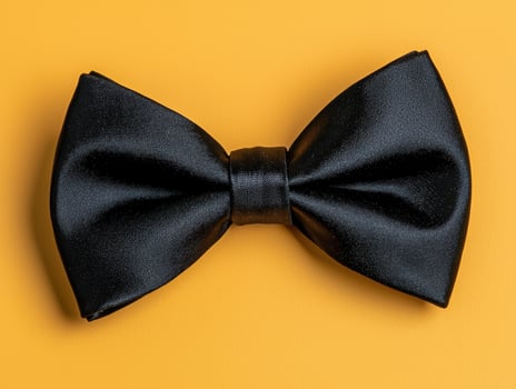 Black bow tie on yellow background photo