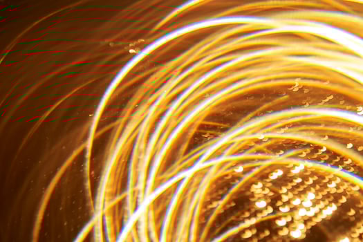 Abstract festive golden background with bright lines of light. photo