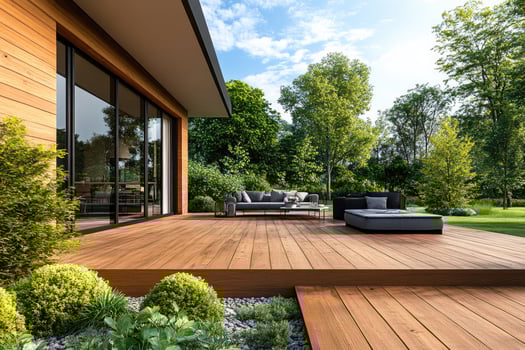 Big wooden terrace with garden furniture near modern house. photo
