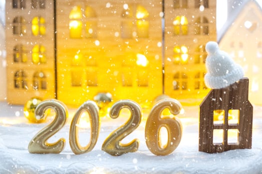 Golden number 2026 and tiny home background of cozy windows of a house with warm light with festive decor of stars,snow and garlands. Greeting card, Happy New Year, cozy home photo