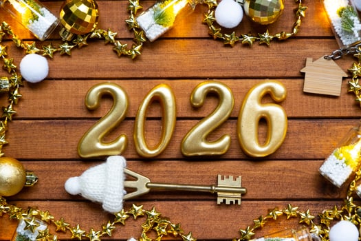 Golden figures number 2026 tiny home background of cozy windows of a house with warm light with festive decor of stars,snow and garlands. Greeting card, Happy New Year, cozy home photo