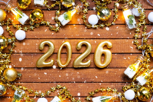 Happy New Year wooden numbers 2026 cozy festive brown wooden background with sequins, snow, lights of garlands. Greetings, postcard. Calendar, cover photo