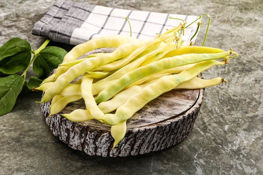 A bunch of beans on a wooden table photo