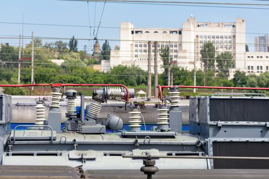 High-voltage insulators on the roof of a passenger train locomotive. photo