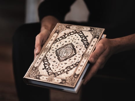 Quran - holy books of Muslims in hands. photo