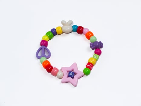 Children's bracelet with white rabbit shape isolated on white background. photo