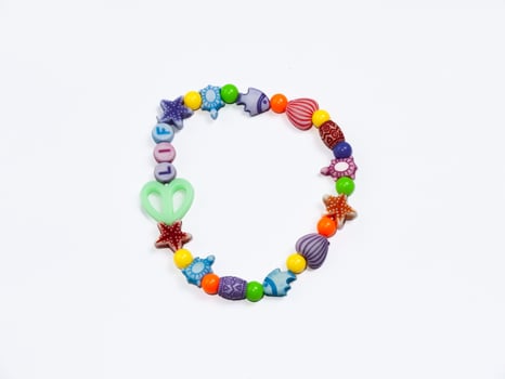 A vibrant bead bracelet featuring various shapes and colors, perfect for kids' accessories or craft projects. photo