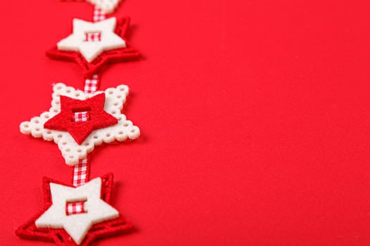 Christmas garland on a red background close photo