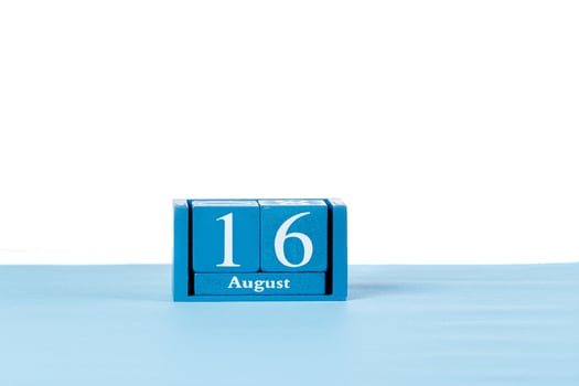 Wooden calendar August 16 on a white background photo