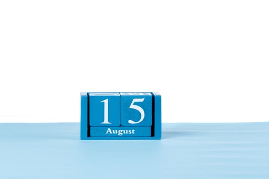 Wooden calendar August 15 on a white background photo