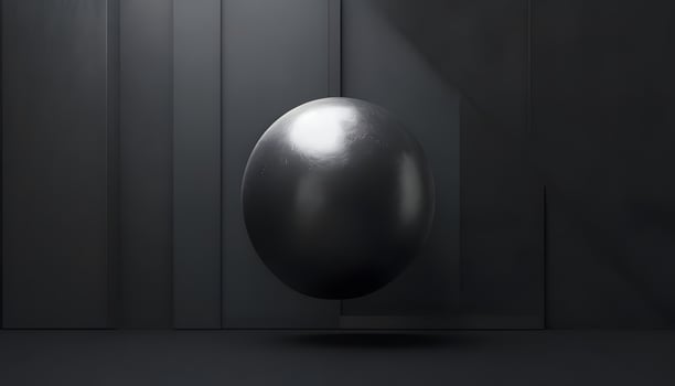 A black and white photo of a shiny ball in a dark room