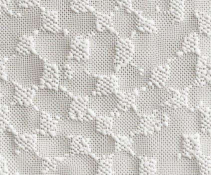 Textured white fabric with intricate patterns in natural light photo