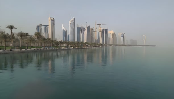 A city skyline is reflected in the water photo