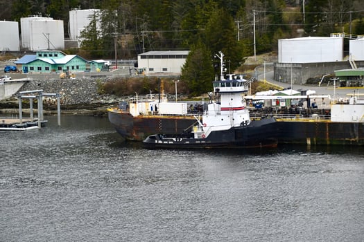 an oil barge and tugboat at a fuel terminal photo