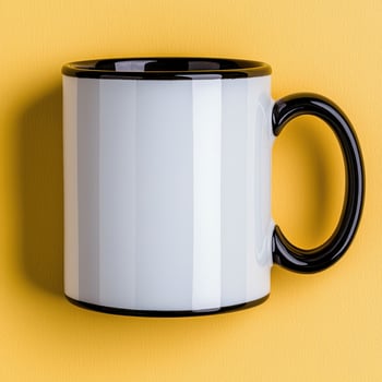 Blank white coffee mug with black rim on yellow background photo