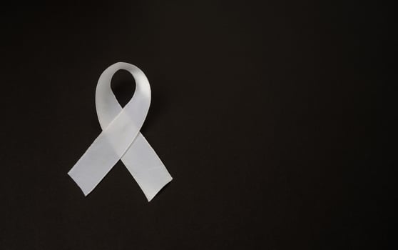 Top view of a white ribbon on a black background photo