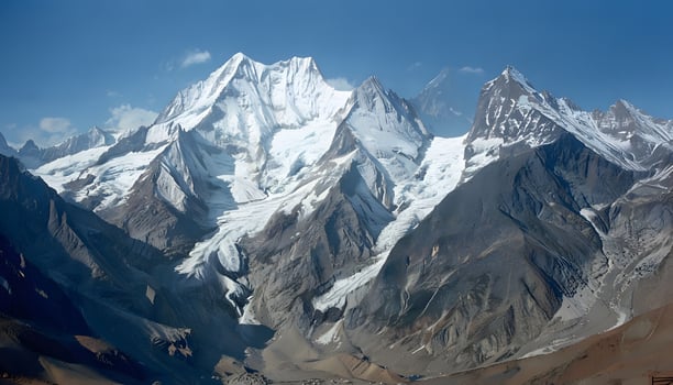 A large mountain range with snow capped peaks photo