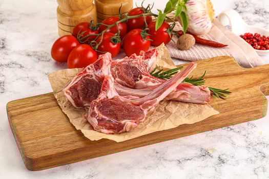 A cutting board with meat and vegetables on it photo