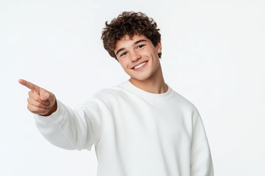 Smiling young man pointing finger at copy space isolated on white background. photo