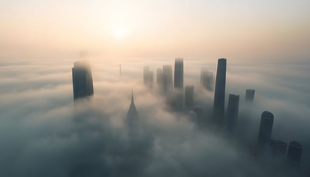 A city skyline is seen through the clouds photo