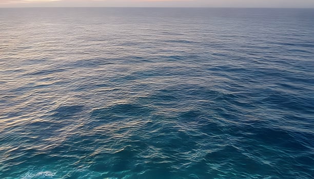 An aerial view of the ocean at sunset photo