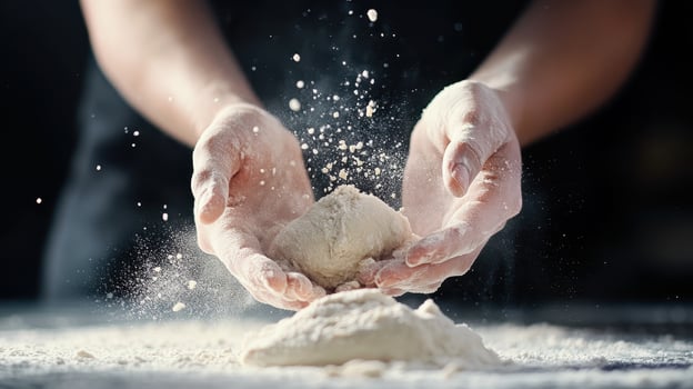 Kneading dough with hands, flour flying in air, creating culinary masterpiece photo