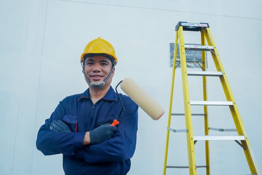 Portrait of a painter with an electric transformer next to him, a yellow staircase. photo