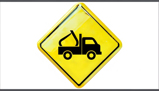 A yellow and black sign with a truck on it photo