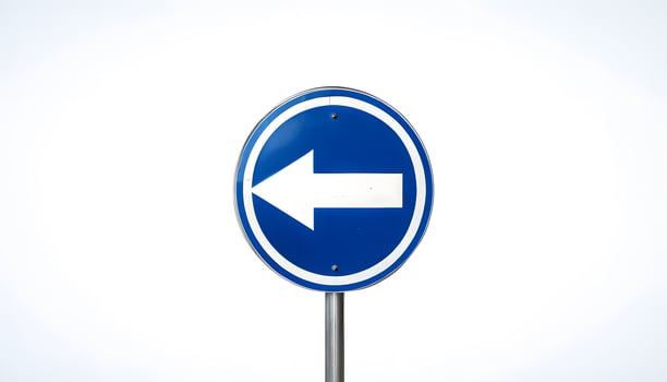 A blue and white road sign with an arrow pointing in the direction of the right photo