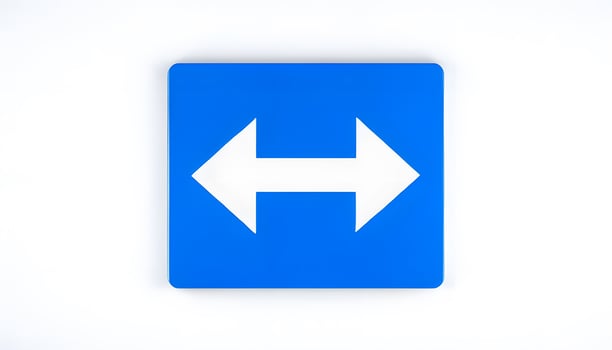 A blue sign with an arrow pointing to the left photo