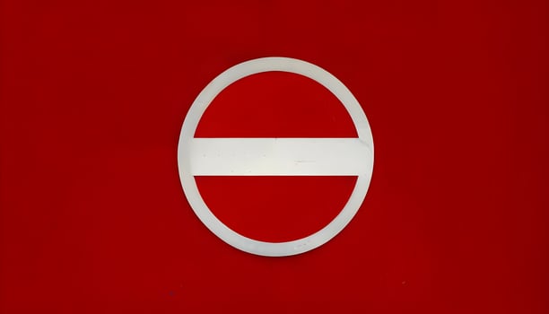 A red and white sign with a circle in the middle photo