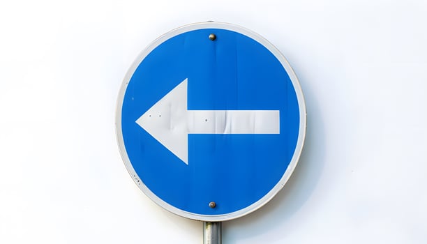 A blue and white sign with an arrow pointing in the direction of the right photo