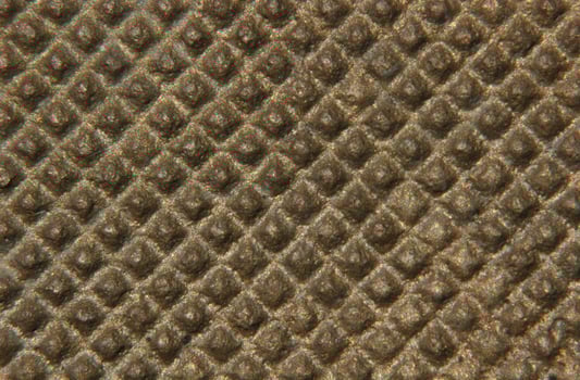 Close-up of a nubby metal surface. photo