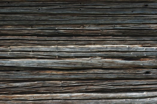 Dark weathered wooden texture of log cabin photo