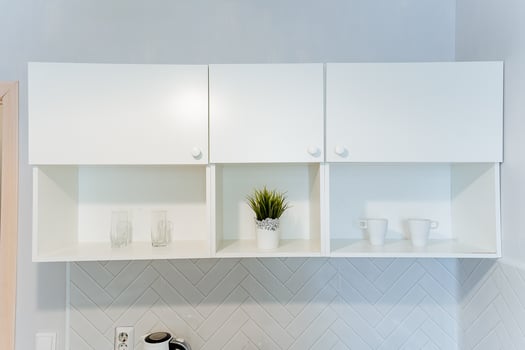Wooden shelving with a houseplant in a kitchen cabinetry photo