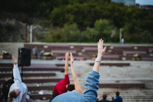 Individuals Actively Participating in a Group Activity at a Vibrant Outdoor Venue Surrounded by Nature and Community photo