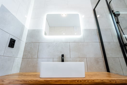 A bathroom with a wooden sink and mirror photo