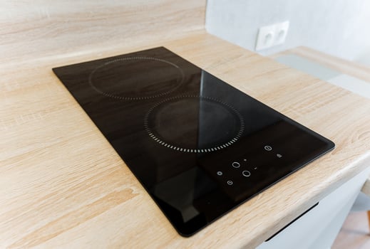 A beautiful stove top oven is elegantly situated on a charming wooden counter in a welldesigned kitchen, which is fully equipped and ready for creating delicious and delightful meals photo
