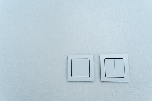 Two white switches on a white surface photo