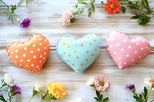Colorful handmade hearts celebrating love and affection on wooden background photo