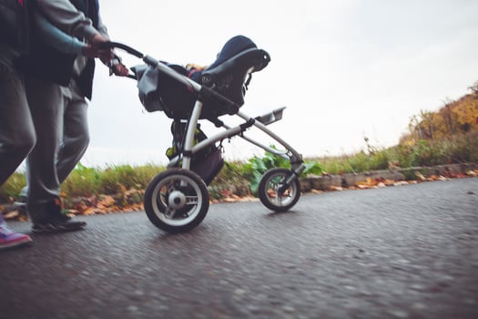 A man pushing a stroller with a baby in it photo