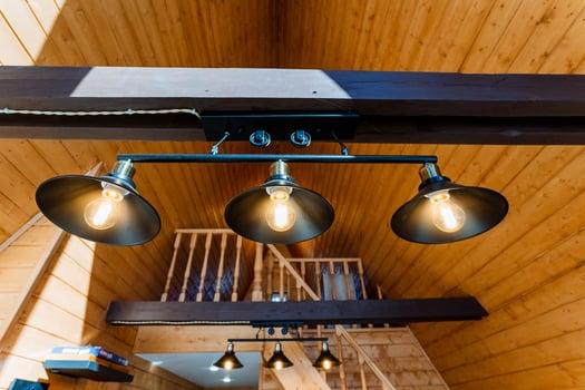 Three light fixtures hanging from the ceiling in a wooden house photo