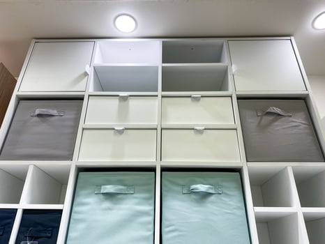 Discover a diverse range of stylish vertical shelves outfitted with colorful bins that not only enhance efficient home organization but also add a decorative touch photo