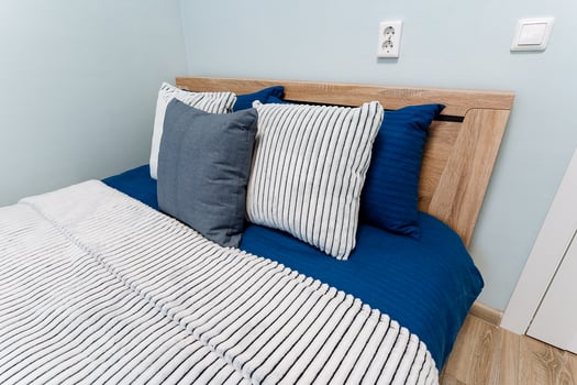 A bed with blue and white striped comforter photo